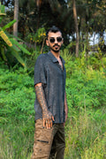 Model wearing Black Illusions bamboo breathable summer shirt with trippy abstract print
